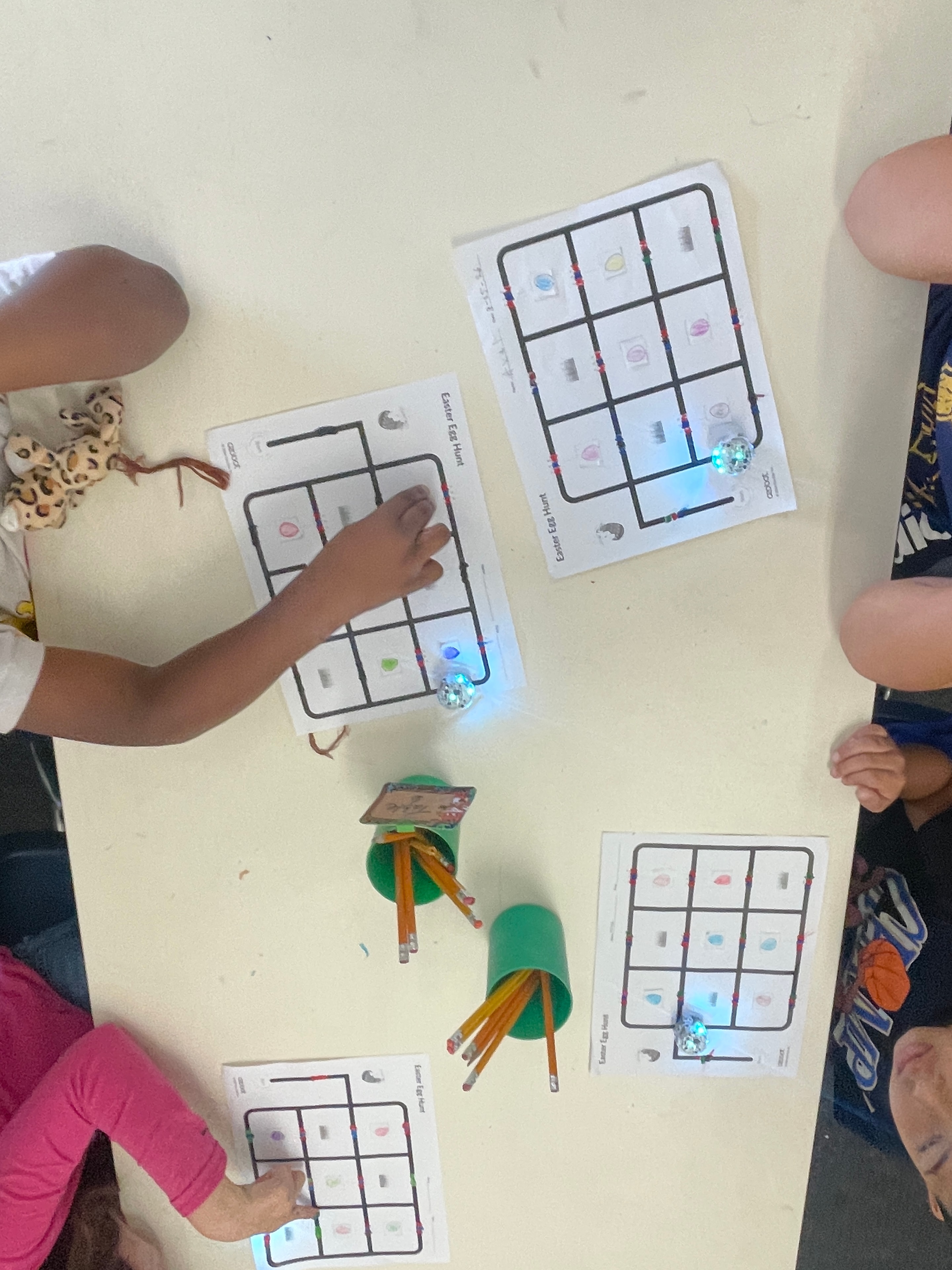 Students using Ozobot robots on Easter Egg Hunt coding activity